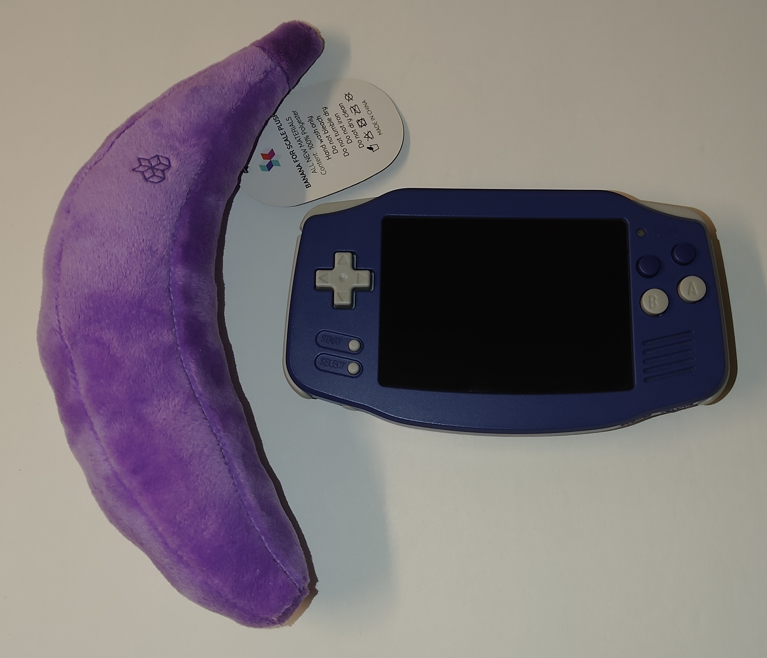 The Anbernic RG34XX with a banana for scale