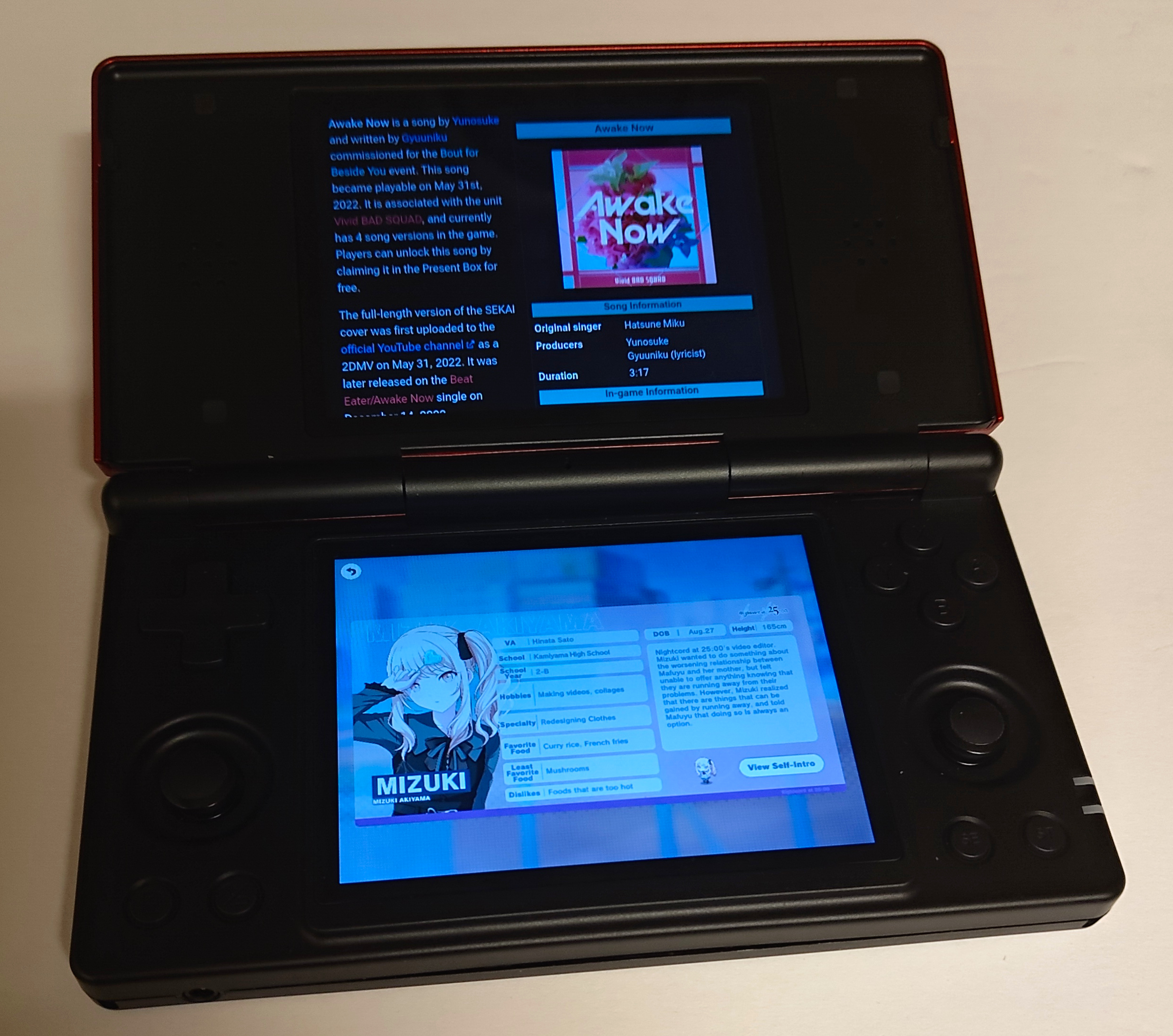 The Anbernic RG DS playing Project Sekai on the bottom screen, with the Sekaipedia open on the top screen
